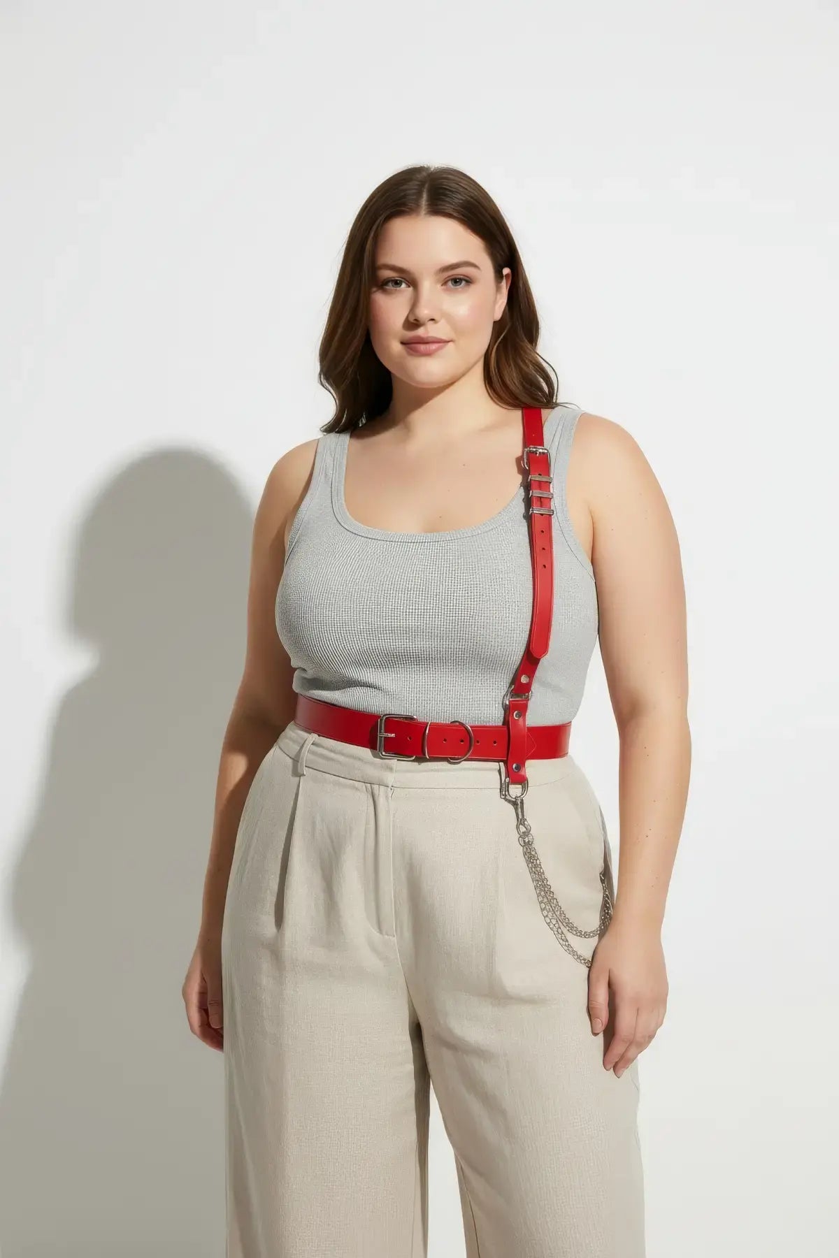 Plus-size red shoulder strap harness belt with vegan leather and metal chain detail.