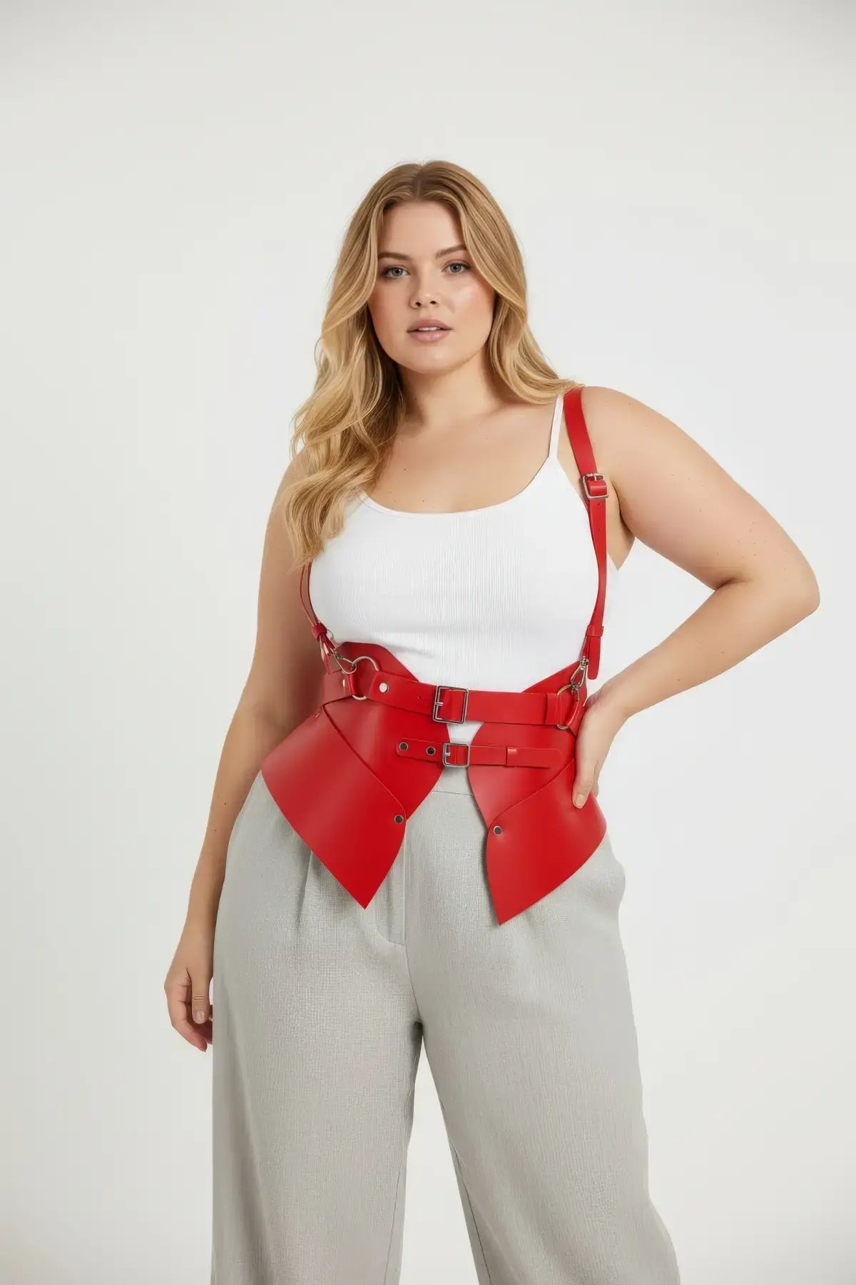 Plus-size red vegan leather shoulder-strap harness vest with double buckles and peplum waist cincher for edgy fashion
