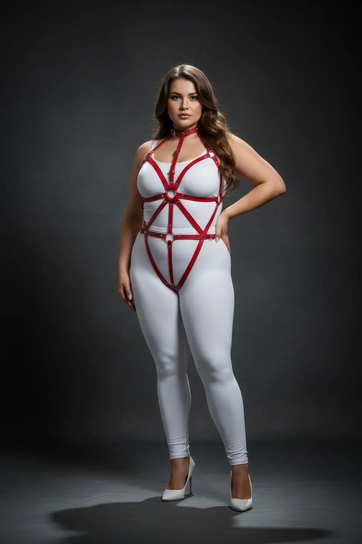 Plus-size red vegan-leather full-body harness with choker, spoke-design, worn over a white bodysuit.