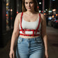 Plus-size red leather body harness with multiple straps and buckles worn over a white tank top.