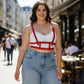 Plus Size Red Strappy Leather Body Harness by HarnessClub, worn over a white bralette.
