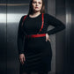 Plus Size Red Strappy Leather Garter Belt worn by a model in a black dress; metal buckles visible.