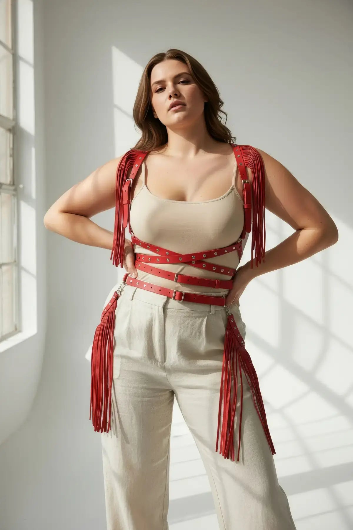 Plus-size red tassel-detail leather body harness by HarnessClub with fringe straps