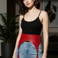 Plus-size red vegan-leather tassel high-waist hip belt harness worn over jeans