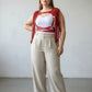 Plus Size Red Tasseled Leather Body Harness by HarnessClub, worn over a white top