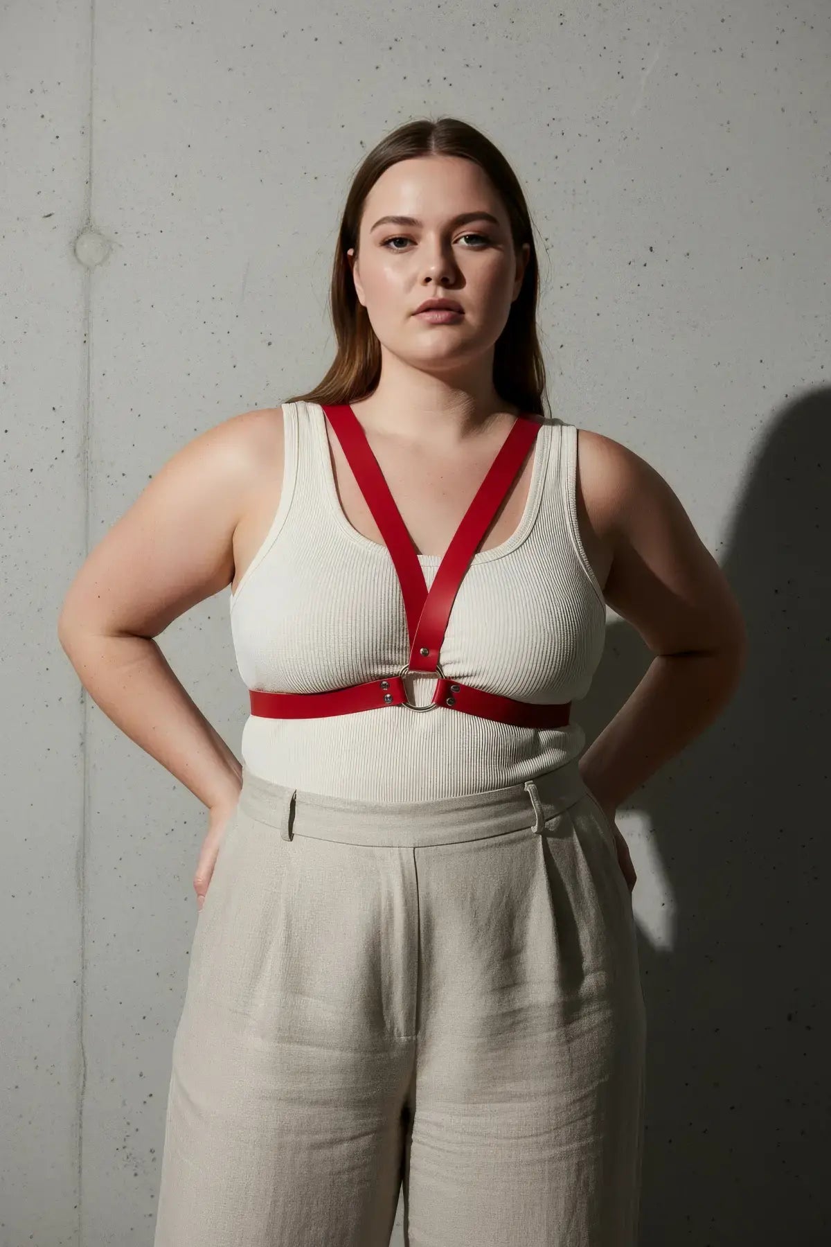 Plus-size red vegan leather V-frame chest harness with O-ring worn over a white top
