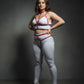 Plus-size red vegan leather harness set with collar and garter straps worn by a model