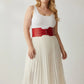 Plus-size red wide three-buckle corset belt by HarnessClub, vegan leather waist cincher worn over white outfit