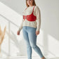 Plus-size red wide corset belt harness in vegan leather worn as an under-bust waist piece over a cream sweater