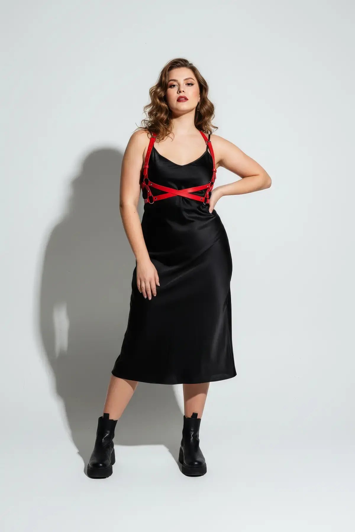 Plus Size Red Wrap Cross-Body Harness by HarnessClub on vegan leather, worn over a black satin dress