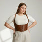 Plus-size tan vegan leather lace-up corset harness with shoulder straps.
