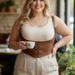 Plus-size tan vegan-leather lace-up corset harness with shoulder straps worn over a cream top