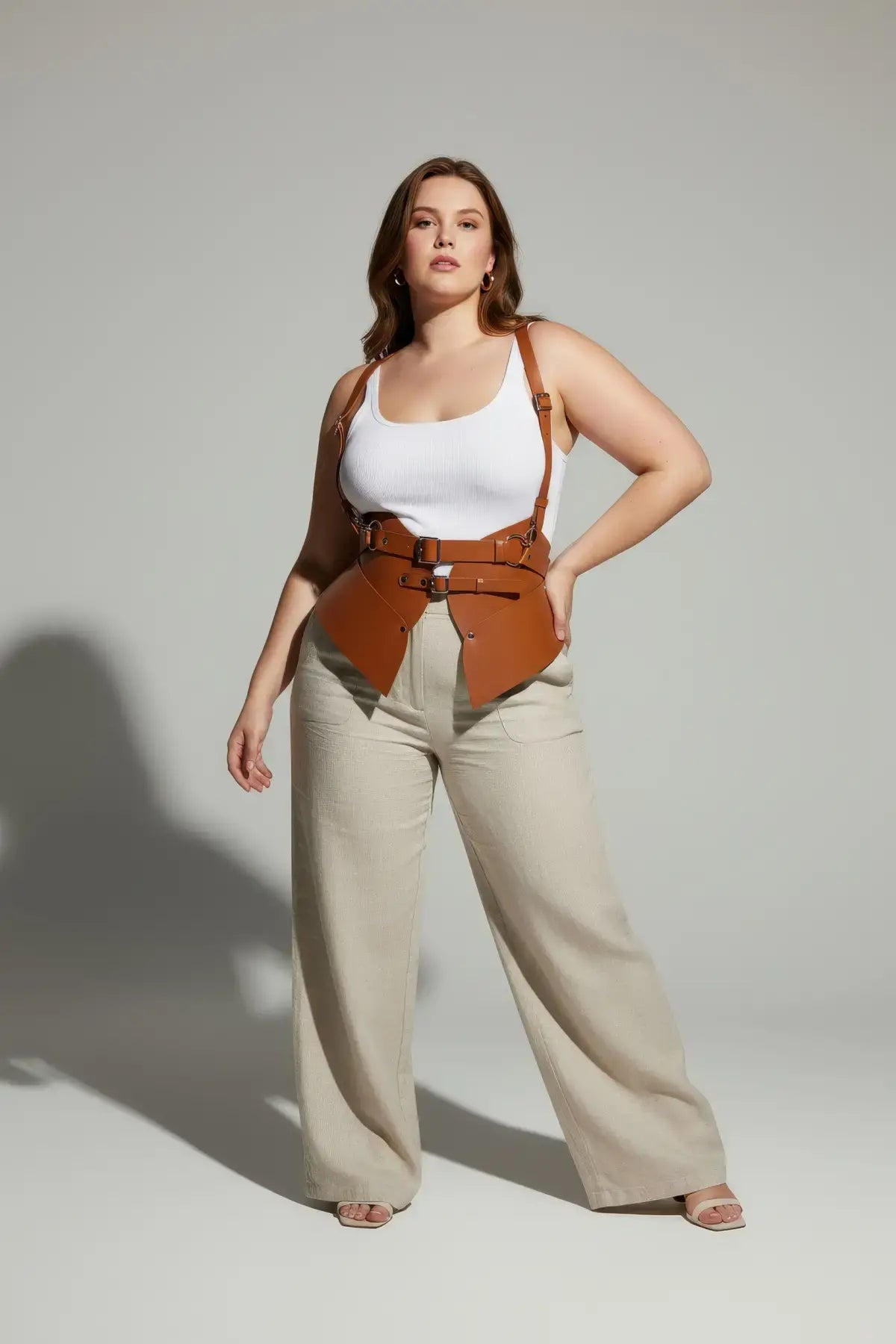 Plus-size tan vegan-leather shoulder-harness vest with double-buckle peplum waist cincher by HarnessClub
