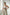 Plus-size tan vegan leather strappy body harness with choker and multiple buckles worn by model