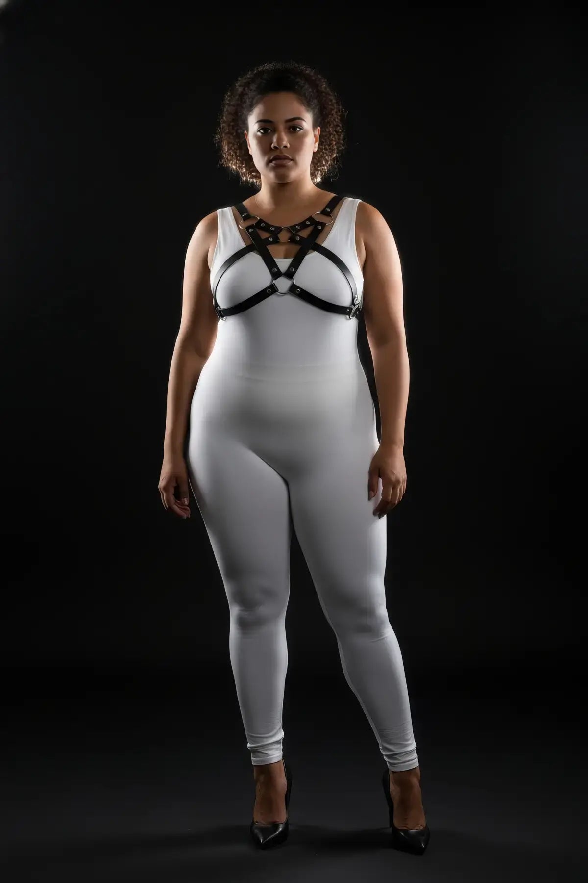 Plus-size vegan-leather chest harness with triple O-rings and cross-straps by HarnessClub on a white bodysuit
