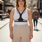 Plus-size vegan leather body harness belt, black, worn over a white tank top