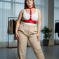 Plus size vegan leather corset harness by HarnessClub worn over white top with red belt-style straps