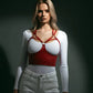 Red vegan-leather caged-strap overbust corset bustier worn over a white top