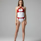 HarnessClub red vegan leather cross-chest harness set with chain accents.