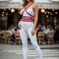 Red vegan-leather body harness with chest and waist straps worn by a model.