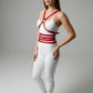Red multi-band body harness by HarnessClub worn over a white bodysuit