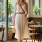 Red thin cross-body harness belt in vegan leather worn over white top HarnessClub