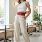 HarnessClub red wide corset belt in vegan leather, modeled at the waist.