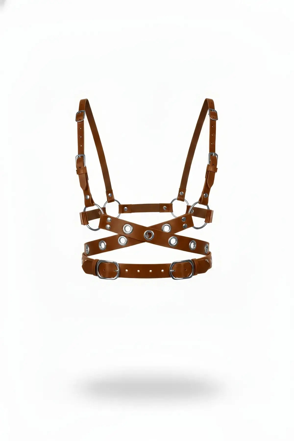 Tan cross-strap grommet chest harness in vegan leather with silver rings and buckles.