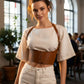 Tan vegan-leather underbust corset belt with straps and lace-up front worn over a white top