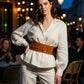 Tan wide O-ring waist belt in vegan leather by HarnessClub, worn over a white blouse.