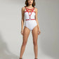 Red star-cross chest and underbust vegan leather harness worn over a white bodysuit.