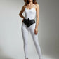 Women's black studded vegan leather corset belt by HarnessClub worn at the waist.