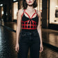 Womens red vegan leather studded open-cage bust harness over a black top by HarnessClub