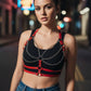 Women's red vegan-leather chain and stud-strap body harness by HarnessClub over a black top