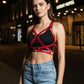 Women's red vegan leather crossbody body harness by HarnessClub worn over a black top