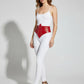 Women's red studded corset belt worn at the waist; vegan leather accessory by HarnessClub