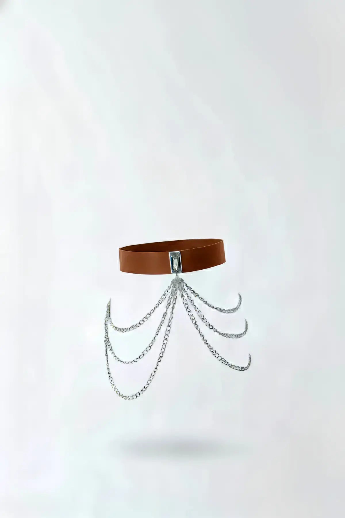 Womens tan vegan leather waist belt with silver multi-chain drape detail.